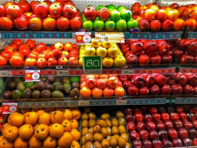 Travel Health Red, yellow and green apples in a grocery store