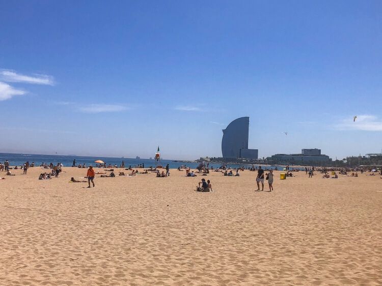 Many tourists enjoying the sun and sand on Barcelonata Beach