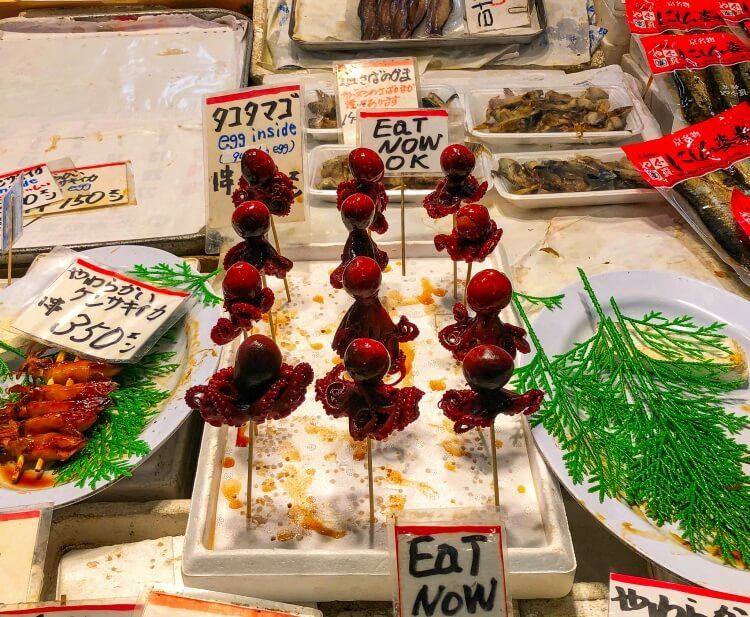 Market in Japan with baby octopus delicacy - travel food