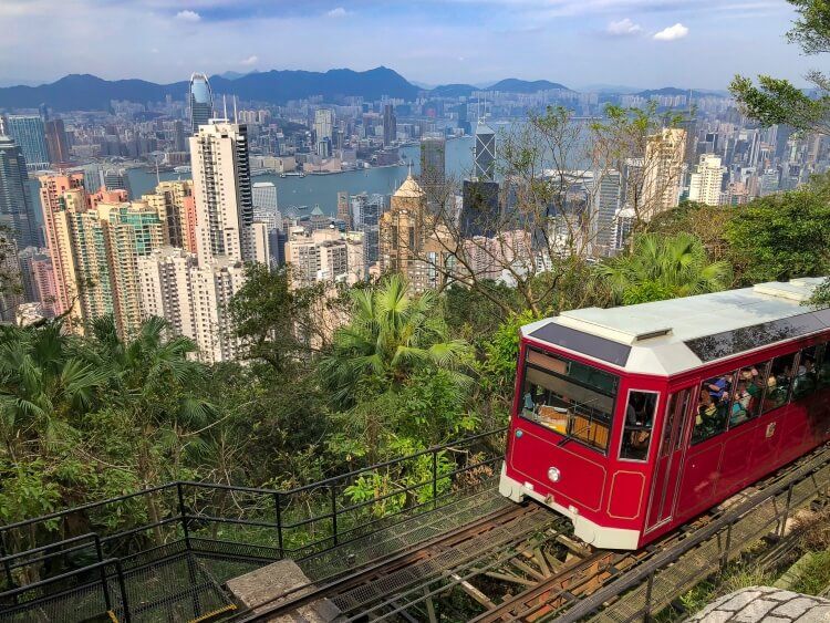 The red tram with Victoria peak in the background
