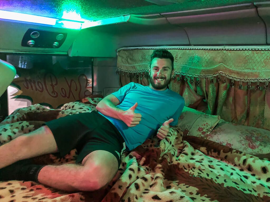 Mark laying in sleeper bus in Vietnam