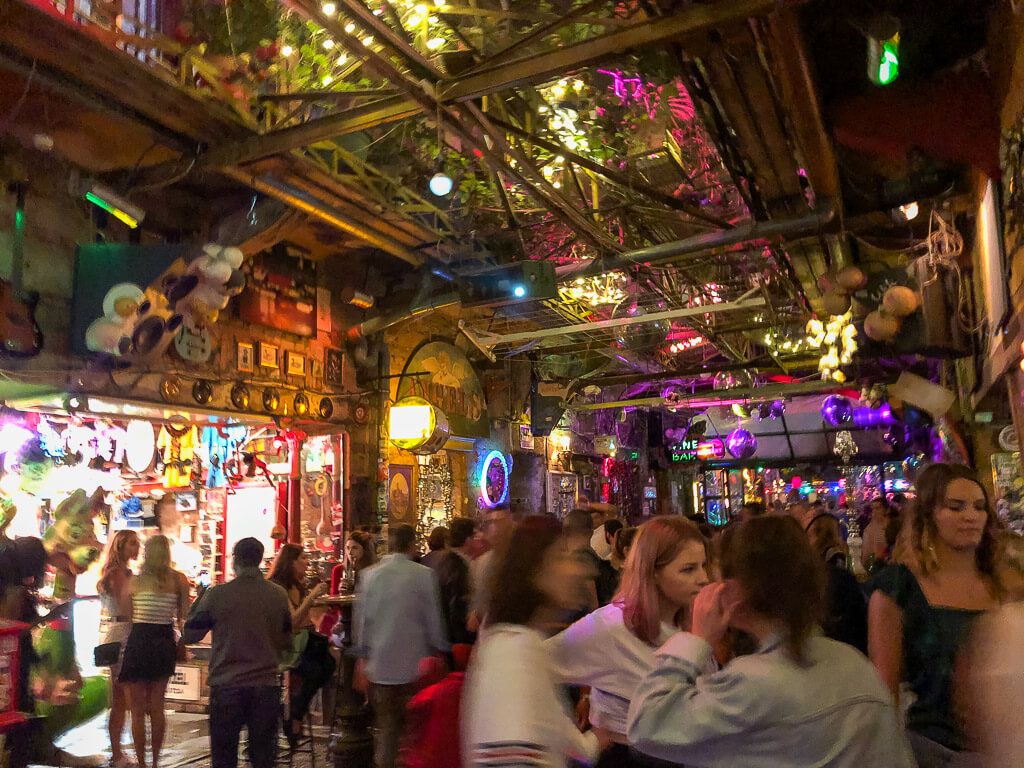 Tourists drinking and dancing inside Szimpla Kert at night