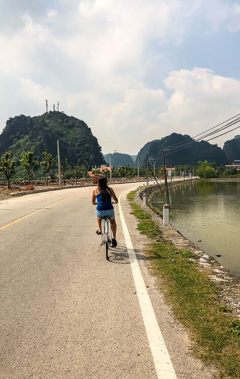 Kristen cycling to Bich Dong Pagoda along a quiet road
