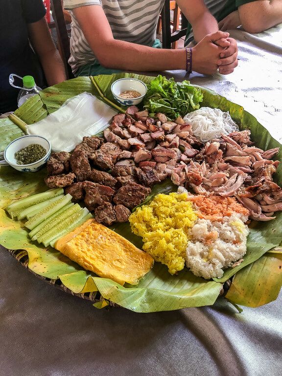 A large plate of meat, rice and vegetables in basket lunch provided during a tour