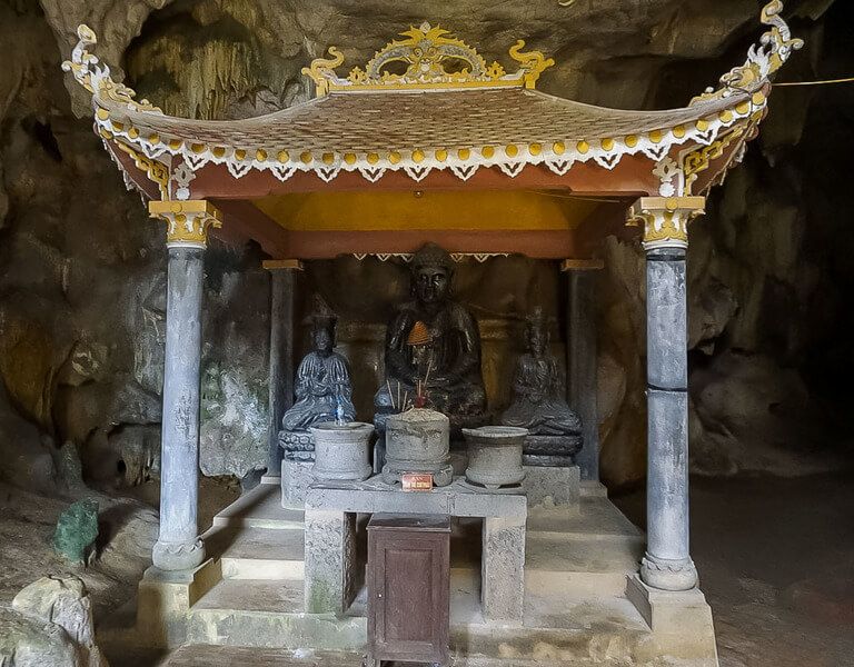 Buddha statues with four columns and roof inside Bich Dong pagoda Tam Coc