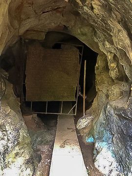 Tiny blocked off entrance to a cave off the beaten path