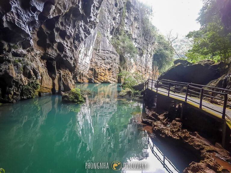 Phong Nha things to do dark cave entrance turquoise water
