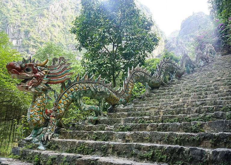 colorful dragon staircase rail along side of stone steps