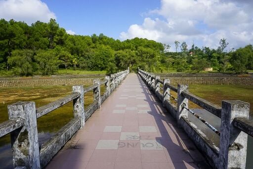 Narrow bridge leading from dragon to the side of lake