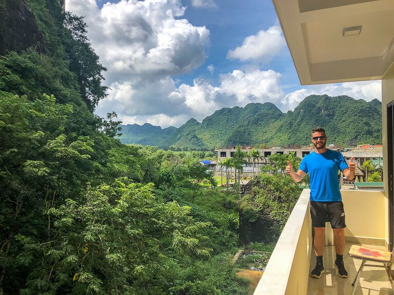 mark on hotel balcony in Phong Nha with spectacular view of green hills