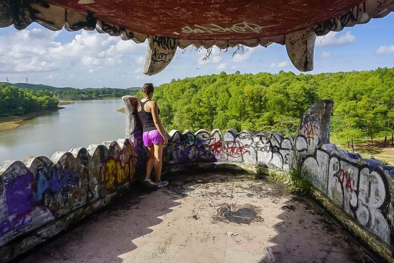 Kristen looking out of a dragons mouth at a lake in hue