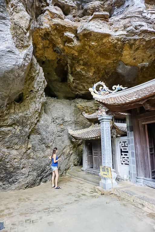 Kristen stood at the side of Trung Pagoda about to enter a tight space into the cave