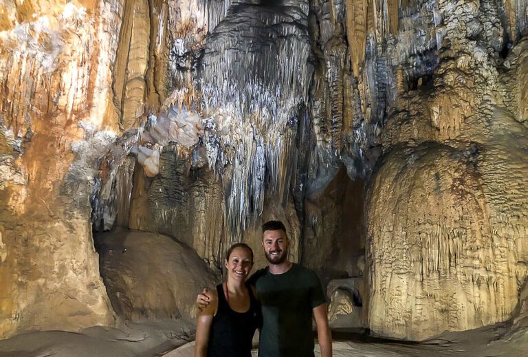 mark and kristen in paradise cave Phong Nha with amazing rock formations behind