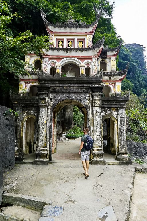 Man walking into Bich Dong pagoda entrance gate in Tam Coc