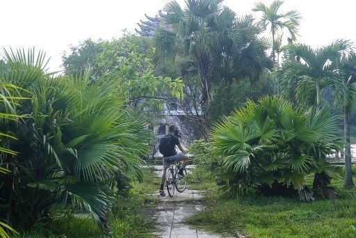 Mark on bike surrounded by green vegetation