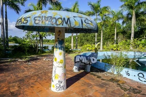 Mushroom water feature with graffiti at abandoned water park hue