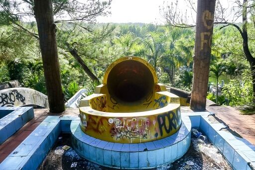 Entrance to yellow tube slide at water park in hue