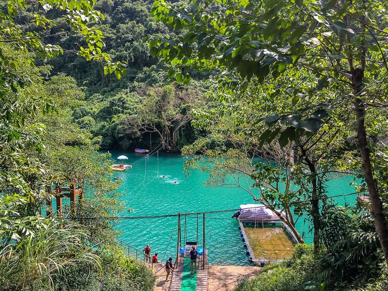 An obstacle course over the bright turquoise river at Dark Cave