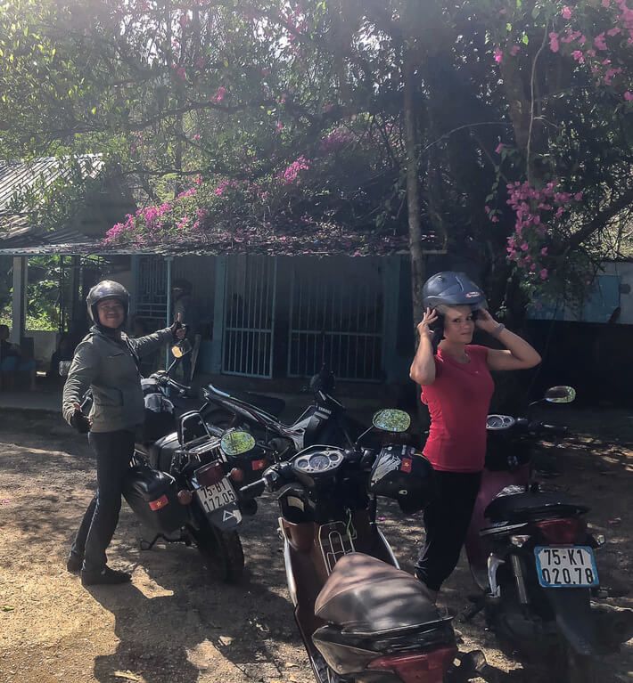 Dr Phu and Kristen stood next to their motorbikes in Vietnam