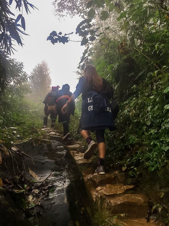Woman walking with local guides during a guided trek