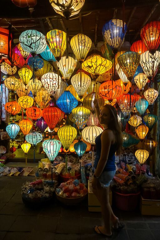 Woman standing in front of several colorful lanterns