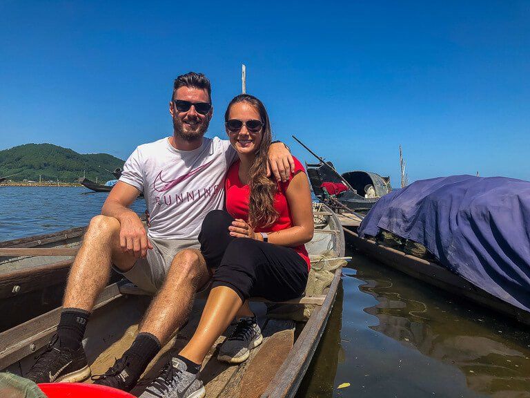 Mark and Kristen on a small wooden boat in a fishing village near hue Vietnam