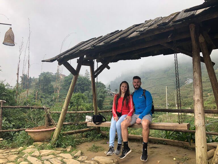 Mark and Kristen on a wooden swing in Cat Cat Village near Sapa Vietnam