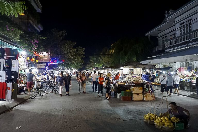 Night market road full of vendors selling goods