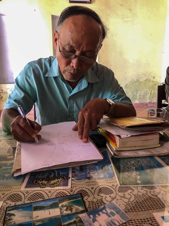 War veteran giving a private tour and drawing important dates on a piece of paper