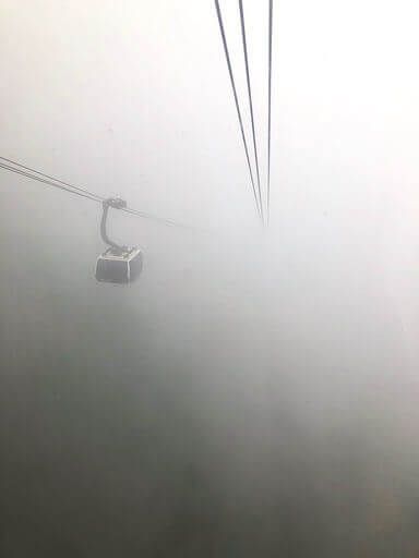 Cable car barely able to see in thick dense clouds in sapa vietnam Fansipan