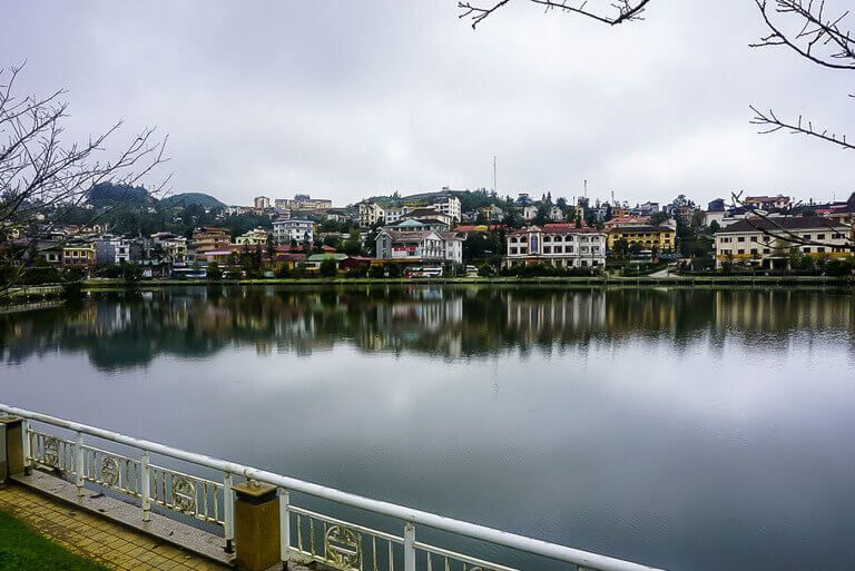 Lake in downtown Sapa Vietnam with reflecting houses on far side