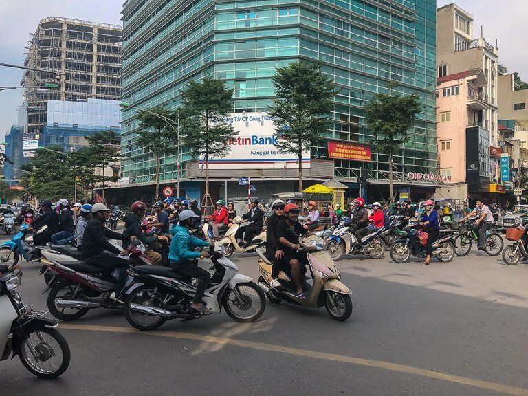 People Crossing Street In The Busy Streets Of Hanoi, Vietnam Stock