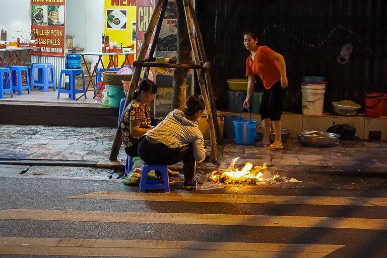 Food being cooked on a street with flames