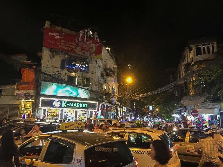 cars and motorbikes trying to cross same roads in hanoi 2 days its enough