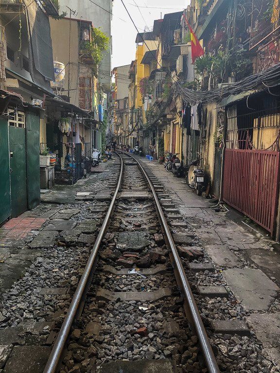 Empty railway track running close to houses