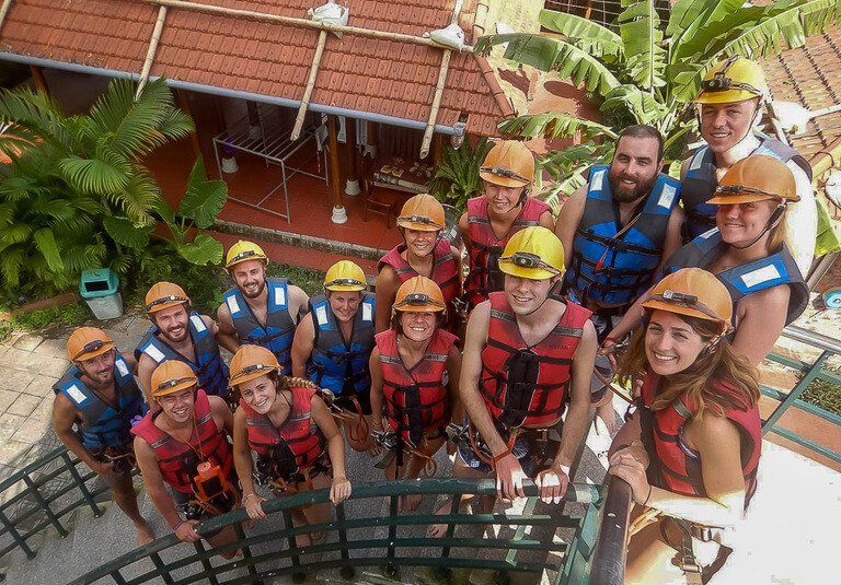 Tour group at Dark Cave Phong Nha on stairs before zipline in life jackets