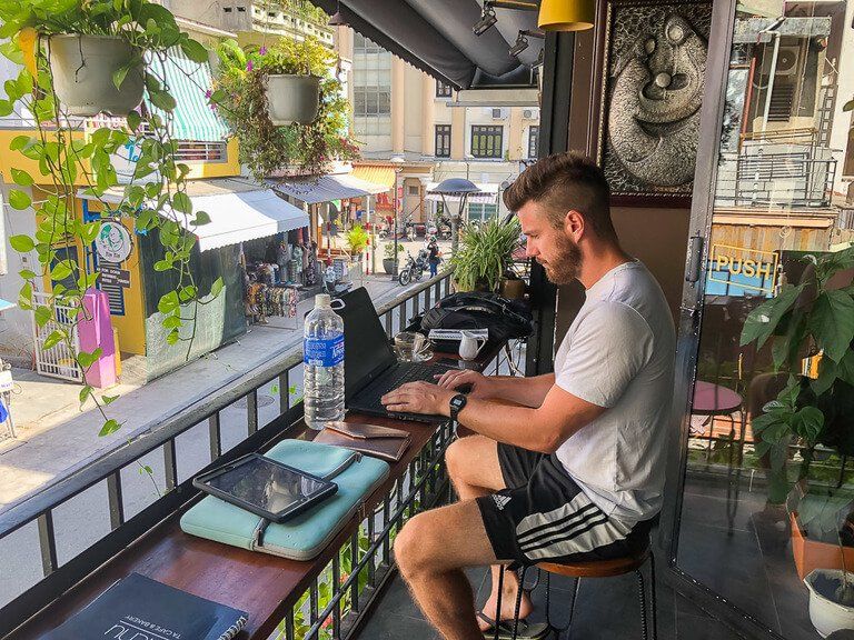 Mark sat in a cafe in hue working on blog using wifi