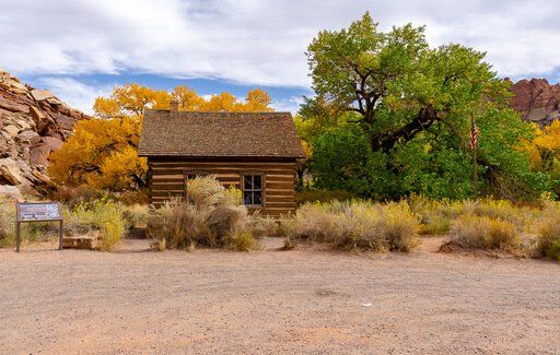 Side angle shot of fruita schoolhouse yellow and green trees