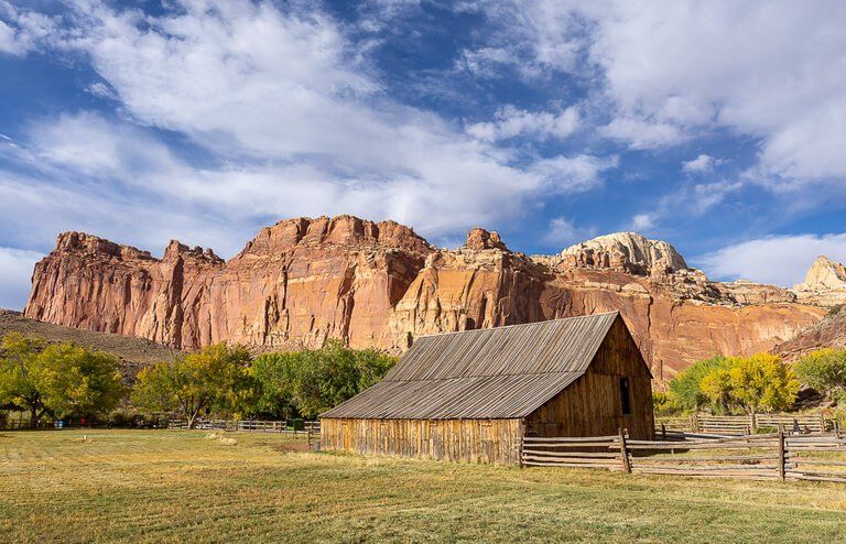 Iconic fruita barn photo with red rock background Utah