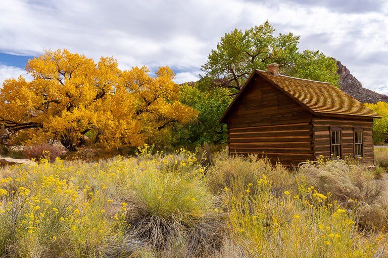 Fruita schoolhouse communal building park ranger talks surrounded by colorful trees in Capitol Reef national park