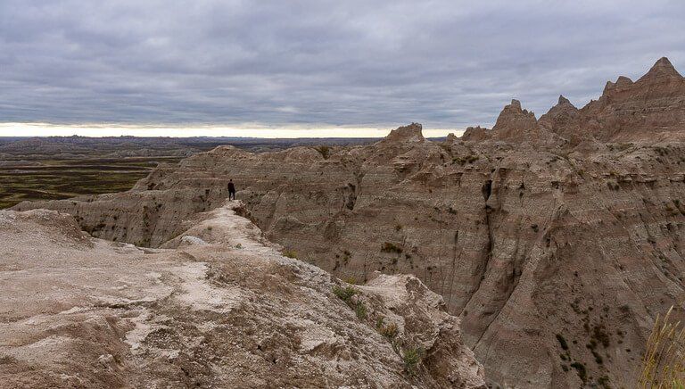 Mark on edge of rock face in badlands cloudy sky