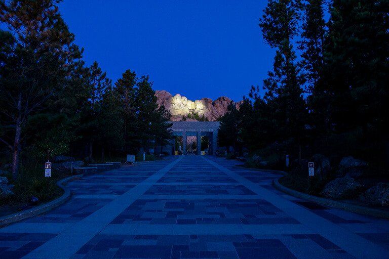 Approaching the entrance to Mount Rushmore with presidents heads small in distance