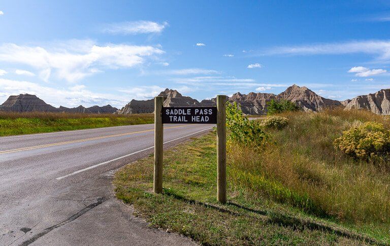 Saddle pass trail head sign post at badlands