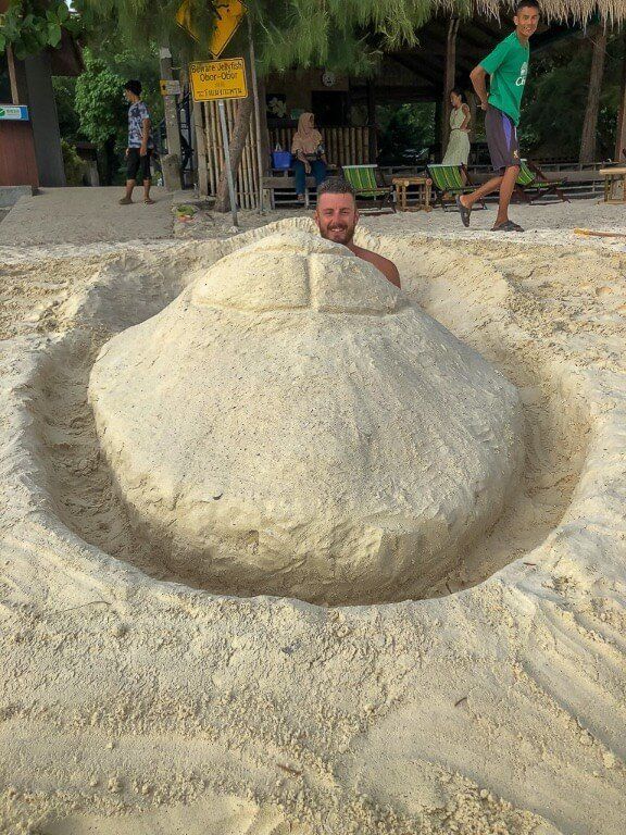 Mark sitting in speedboat built into Pattaya Beach Thailand with impressed onlookers