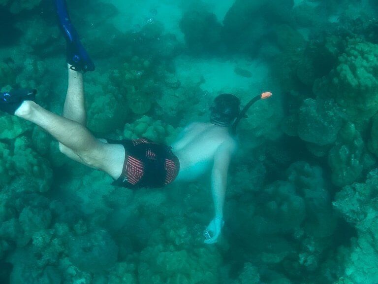 Mark snorkelling diving towards coral near Koh Lipe Thailand