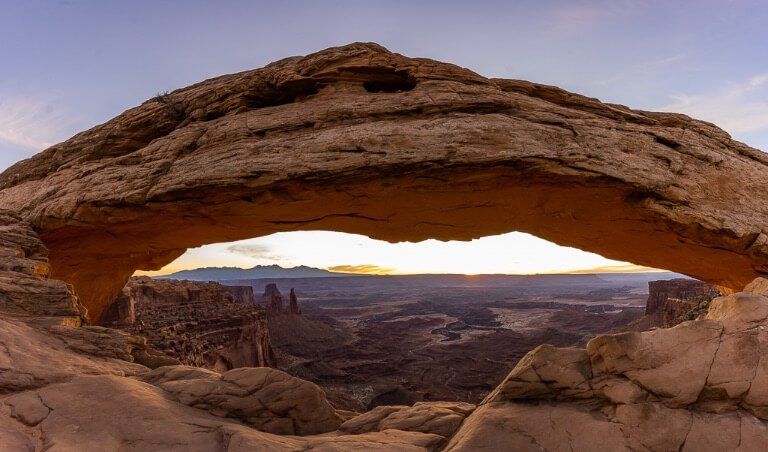 Mesa arch panoramic three photos stitched together at sunrise in canyonlands Utah
