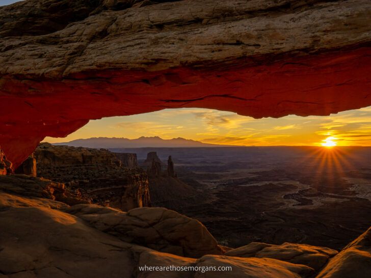 Starburst of the sun at Mesa Arch during sunrise