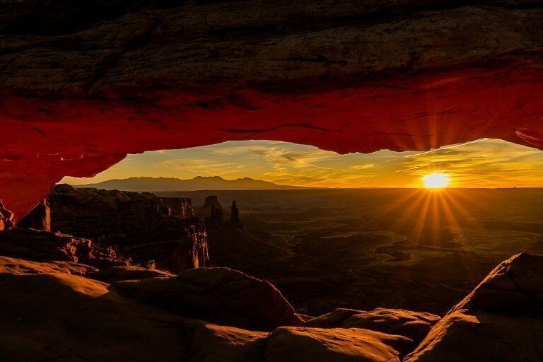 Underexposed dark sunrise at Mesa Arch in Canyonlands National Park Utah