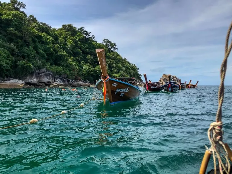 Long tail boats congregating around a snorkel site in Andaman sea
