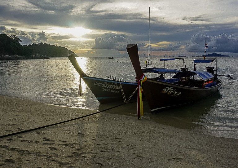 Long tail wooden boats in Thailand at sunset amazing sky